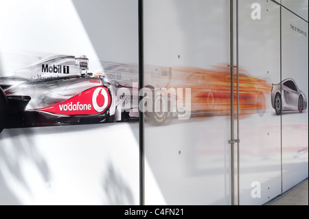 McLaren Showroom with window graphic showing a McLaren Formula 1 ca rand the new McLaren MP4-12C. Stock Photo