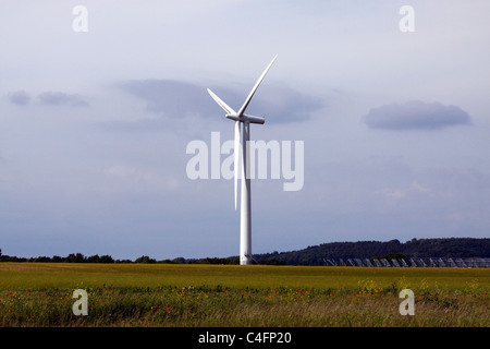 Wind Turbines in a meadow on a wind farm Stock Photo