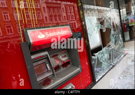 Vandalised bank ATM and smashed window broken by anti capitalists protesters, London, UK Stock Photo