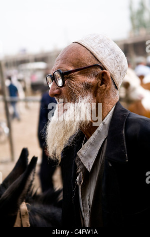 portrait of an Uighur man taken in the colorful Sunday market in Kashgar. Stock Photo