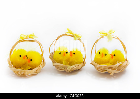 three baskets of easter chicks on a white background Stock Photo