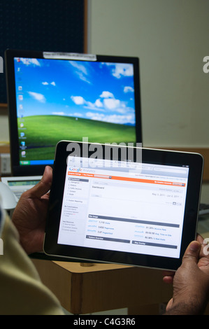 Man using iPad in office Stock Photo