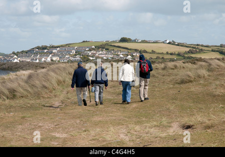 Walkers on the South West Coastal Path across the Northam Burrows Country Park towards Appledore in North Devon England UK Stock Photo