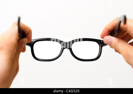 Putting on black glasses Stock Photo