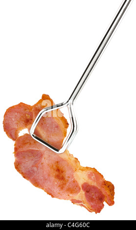 Single rasher of bacon picked up with kitchen tongs Stock Photo