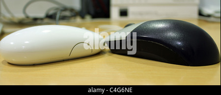 Mouse of a mac computer and PC side by side Stock Photo