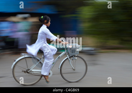 a girl in Ao Dai on a bike, Mekong Delta, Vietnam Stock Photo
