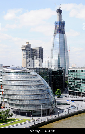 City Hall & More London scoop riverside development Shard landmark skyscraper tower building construction site and Guys Hospital  Southwark England UK Stock Photo