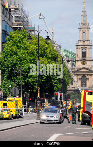 St Mary Le Strand Church tower stands beyond firefighter on telescopic access platform at major fire in Marconi House Aldwych Stock Photo