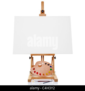 Photo of an artists easel with a blank canvas plus palette of paint and brushes, isolated on a white background. Stock Photo