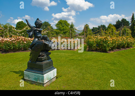 A bronze statue, little boy wearing helmet and rides vulture bird in rose garden at Queen Mary gardens Regent's Park, London, UK Stock Photo