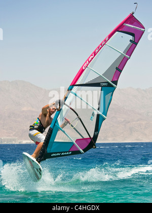 A windsurfer performing tricks on the red sea at the resort of Eilat in Israel. Stock Photo