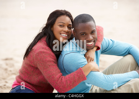 Young couple Embracing on beach Stock Photo