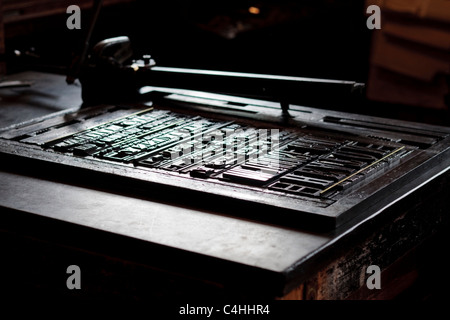 Old fashioned layout table with metal letters at the printshop in Beamish museum Durham England Stock Photo