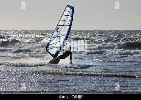 Windsurfer in wetsuit windsurfing on the North Sea Stock Photo