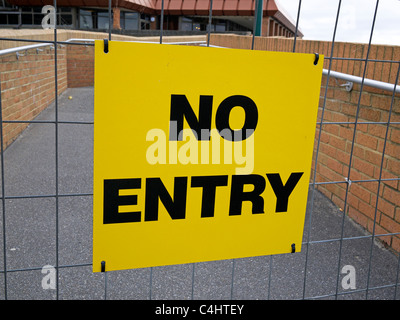 No entry sign with a metal mesh barrier blocking a ramp access along West Cliff Road Bournemouth UK Stock Photo