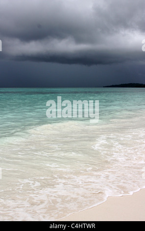 Storm Cloud over Pristine Ohoililir Beach in Indonesia Stock Photo