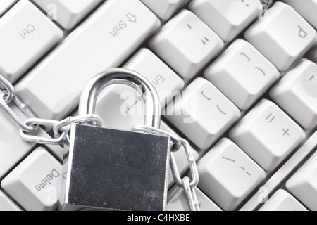 Computer keyboard secured with chain and padlock Stock Photo