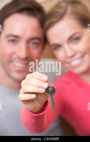 Young couple holding key in hand Stock Photo