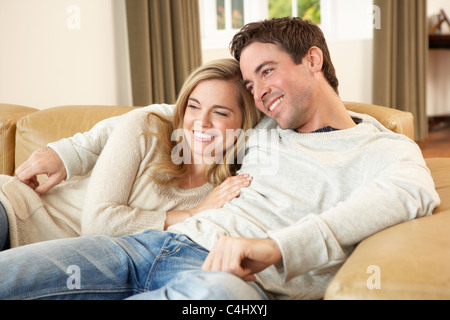 Young couple sitting and relaxing on sofa