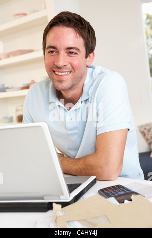 Young man working with laptop computer Stock Photo