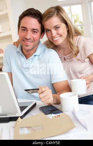 Young couple using credit card on the internet Stock Photo