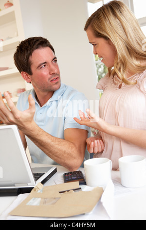 Young couple discussing their finance over laptop computer Stock Photo