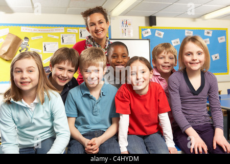 Schoolchildren In classroom with teacher Stock Photo