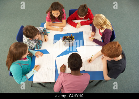 Overhead View Of Schoolchildren Working Together At Desk Stock Photo