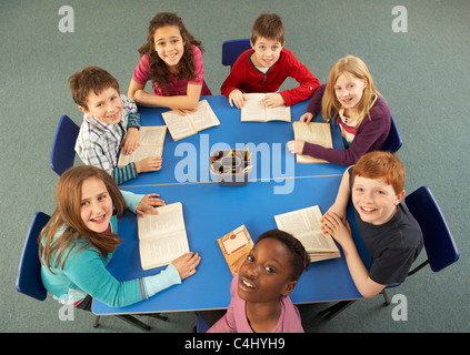 Overhead View Of Schoolchildren Working Together At Desk Stock Photo