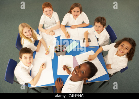 Overhead View Of Schoolchildren Working Together At Desk Stock Photo