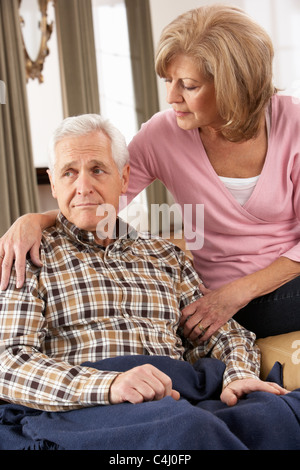 Senior Woman Caring For Sick Husband Stock Photo