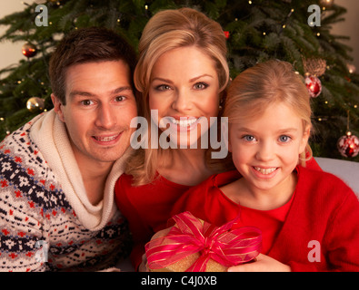 Family Opening Christmas Gifts At Home Stock Photo