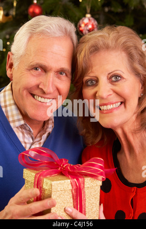 Senior Couple Exchanging Christmas Gifts Stock Photo