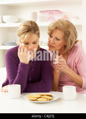 Mother Consoling Grown Up Daughter Stock Photo