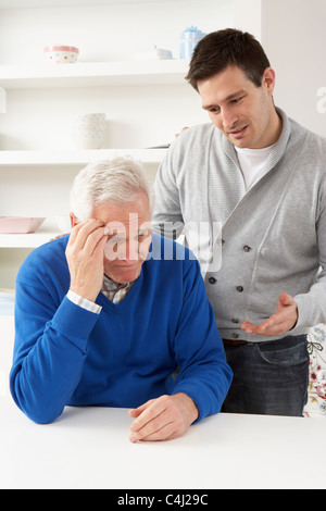 Grown Up Son Consoling Senior Parent Stock Photo