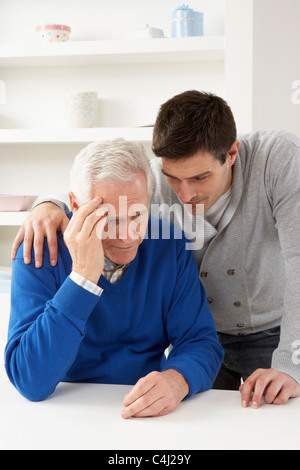 Grown Up Son Consoling Senior Parent Stock Photo