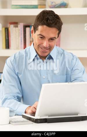 Man Working From Home Using Laptop Stock Photo