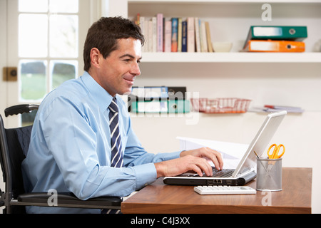 Man Working From Home Using Laptop Stock Photo