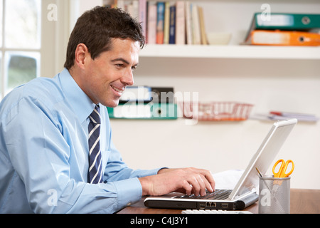 Man Working From Home Using Laptop Stock Photo