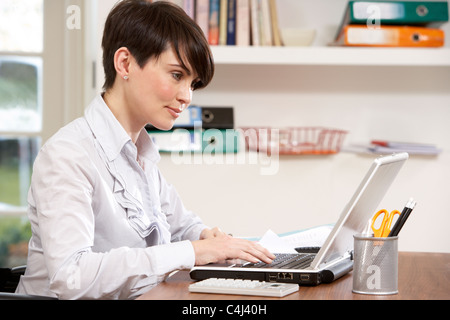 Woman Working From Home Using Laptop Stock Photo