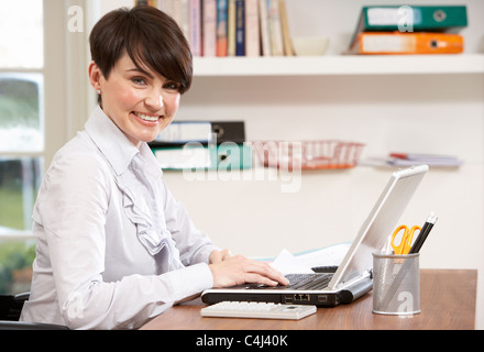 Woman Working From Home Using Laptop Stock Photo