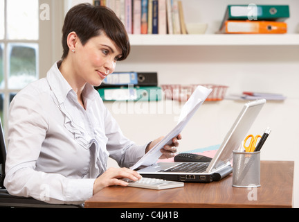 Woman Working From Home Using Laptop Stock Photo