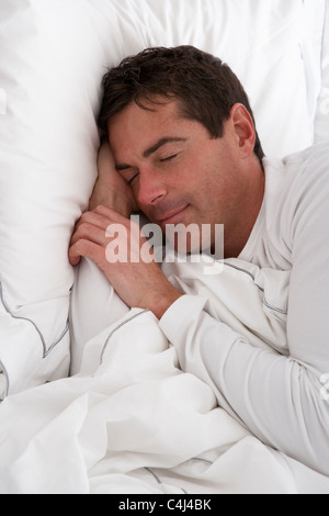 Man Sleeping Peacefully In Bed Stock Photo