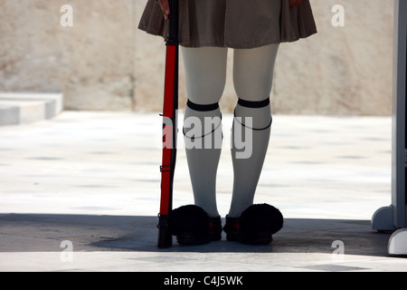 Legs of a greek soldier of the Presidential Guard outside the tomb of the unknown soldier and the Greek Parliament Stock Photo