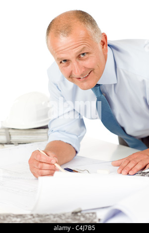 Closeup of senior man working on blueprints and construction plans Stock Photo