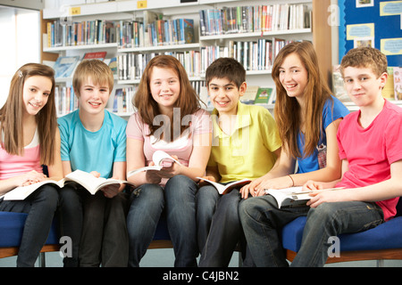 Teenage Students In Library Reading Books Stock Photo