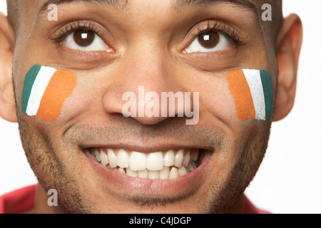 Young Male Sports Fan With Ivory Coast Flag Painted On Face Stock Photo