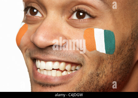 Young Male Sports Fan With Ivory Coast Flag Painted On Face Stock Photo