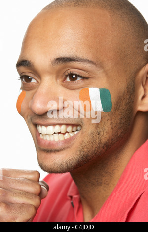 Young Male Sports Fan With Ivory Coast Flag Painted On Face Stock Photo